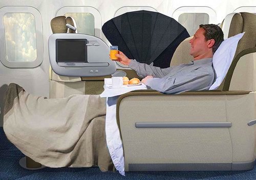 OpenSkies business class seat with man reclining in it